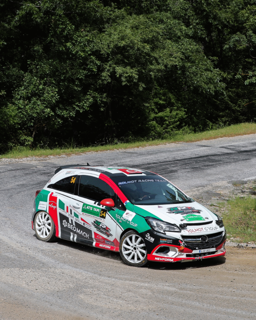 Rolmot Racing Team Opel Corsa rally car sliding through a gravel corner during the Turkish rally championship
