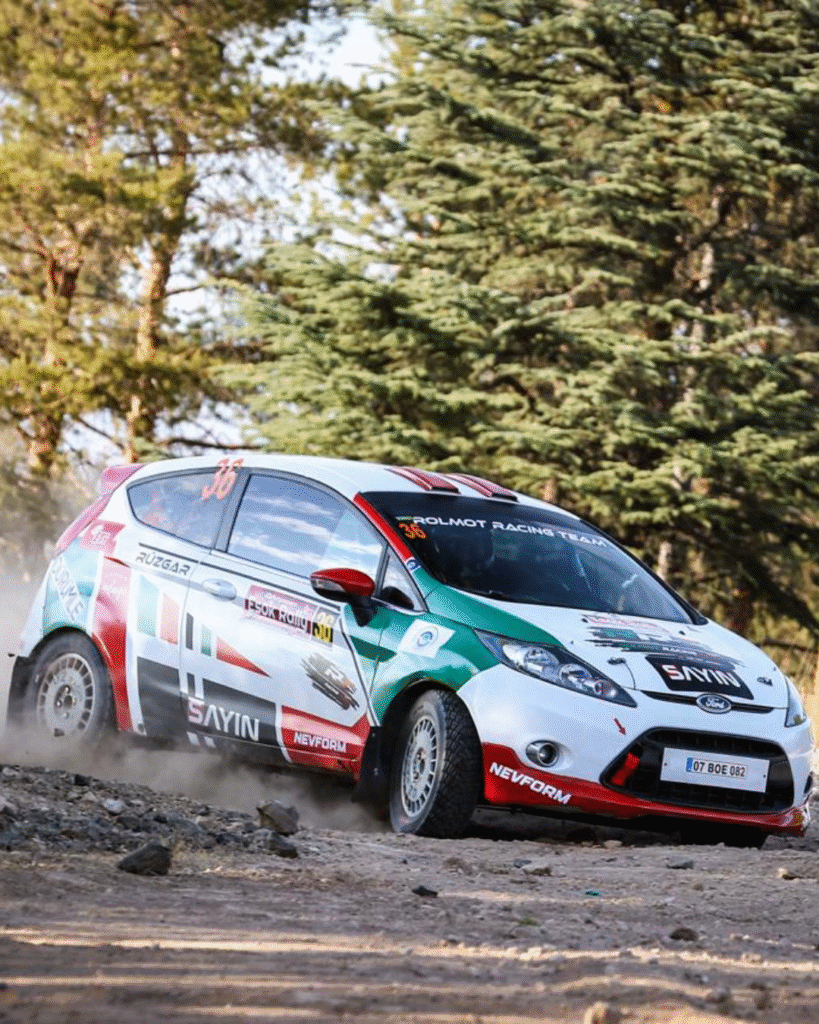 Rolmot Racing Team Ford Fiesta rally car drifting on a rocky gravel road during a rally stage in Turkey